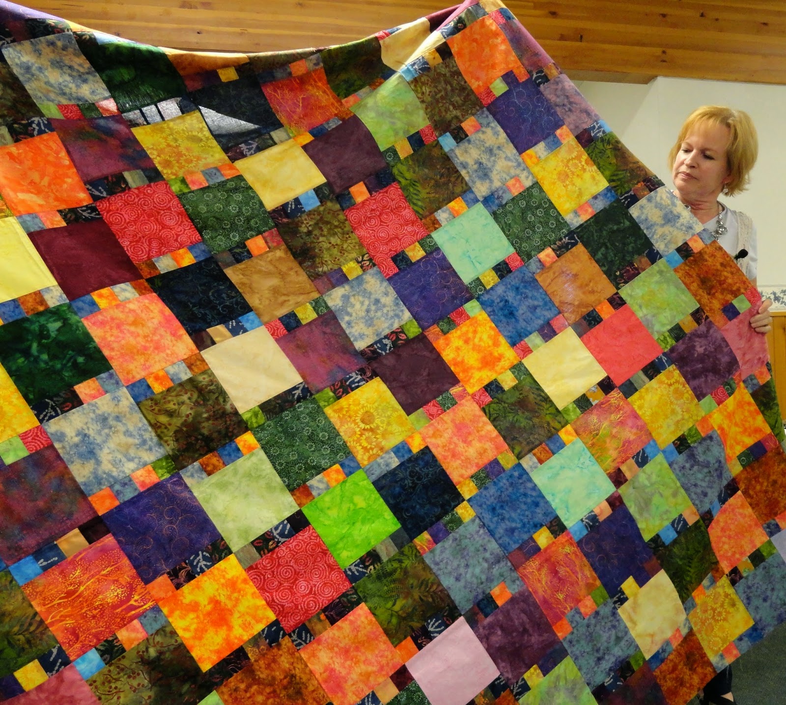 She showed many examples of her different quilts:
