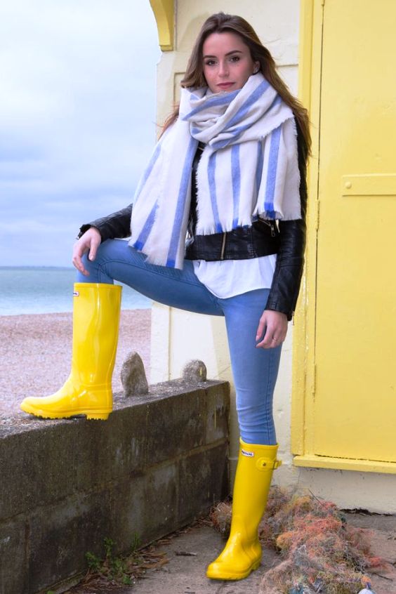 Woman wearing jeans and yellow rain boots