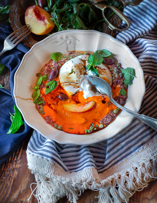 three little halves Burrata with Red Pepper Cream and Olive "Caviar"