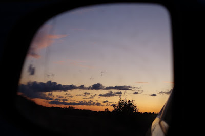 leaving sunset behind in a rear view mirror