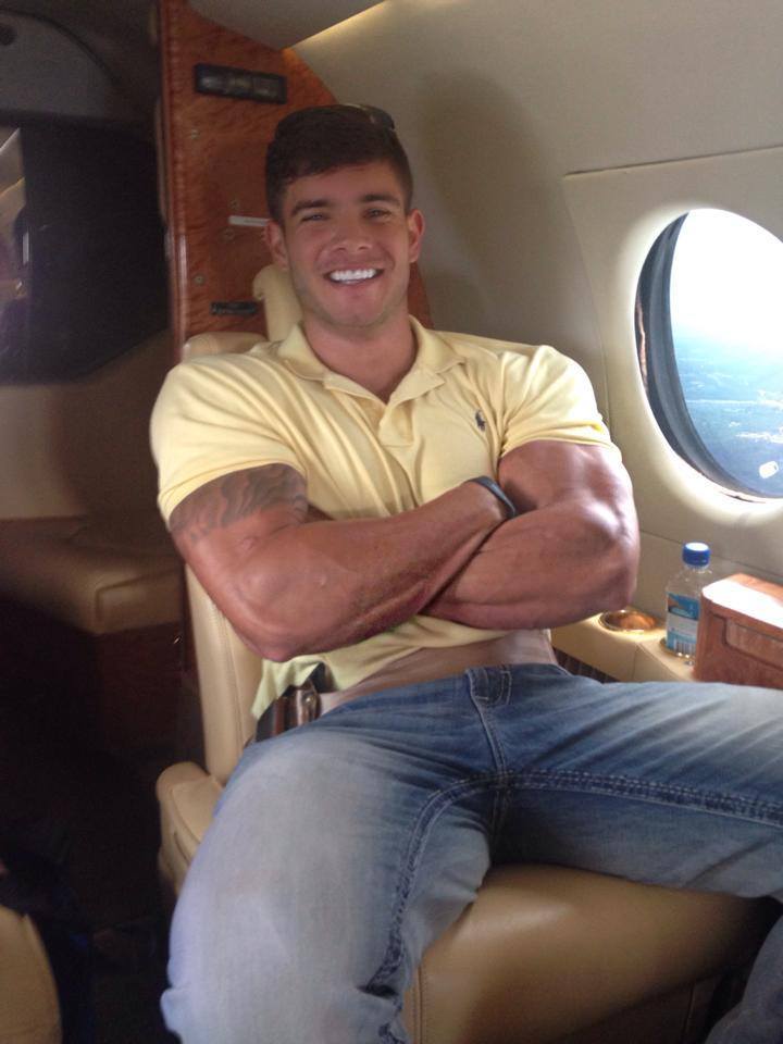 strong-masculine-sexy-big-biceps-hunk-smiling-private-jet-flying-guy-jeans