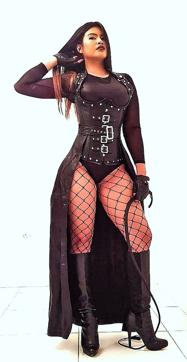 Sexy strict Mistress wearing a leather corset, fishnet and black boots