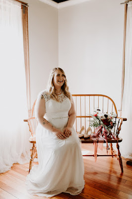 bride getting ready in dress and laughing