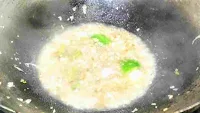 Vegetables and herbs simmering in a wok for chicken manchurian recipe