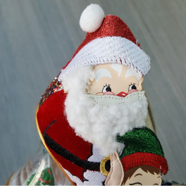 close up of Santa Claus applique face on side of shoe with fluffy beard and pompom  hat