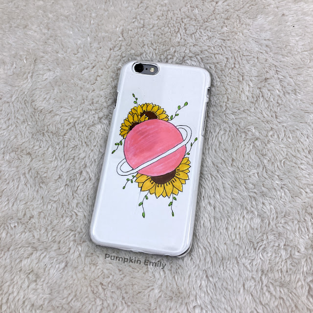 DIY phone case with a planet and flowers.