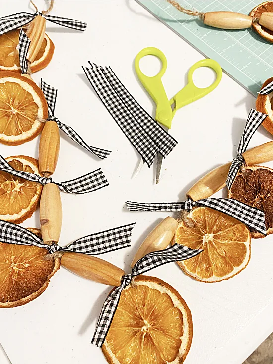 orange slice garland with black and white ribbons