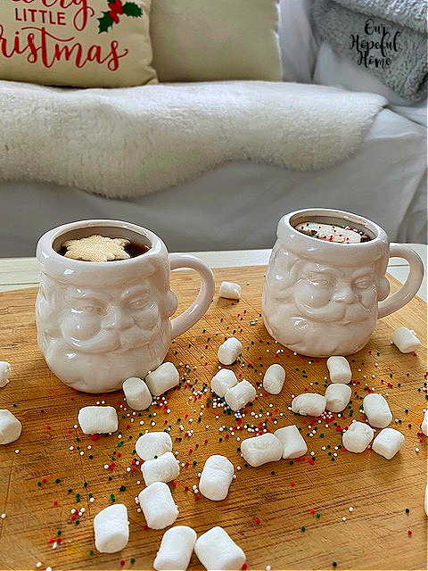 two white Santa Claus cocoa mugs snowflake marshmallow toppers