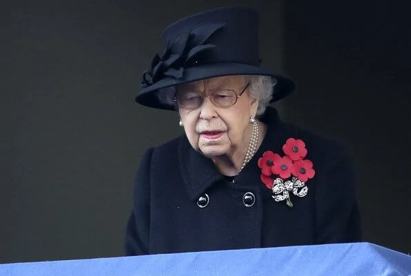 Kate Middleton wore a bespoke black military coat by Alexander McQueen, and a Philip Treacy hat. Queen's diamond and pearl earrings