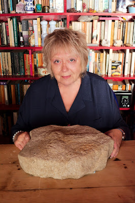 Godmanchester Millstone with Phallus held by Curator Kate Hadley