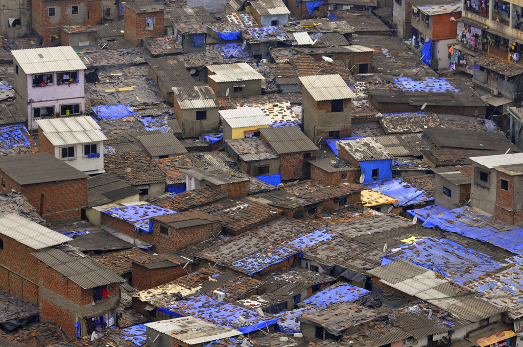 Image of Dharavi from above which is a vivid scenery of blue and brown colors.