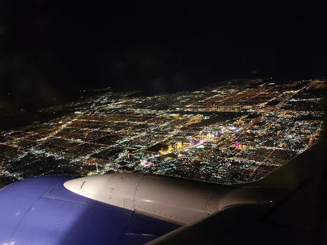 View of Las Vegas at night from over airplane wing when I chose to fly standby