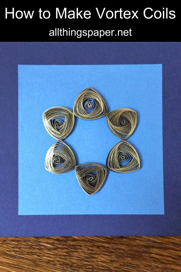 gilded vortex coil six-point star on a quilled card