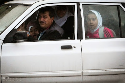 A little girl watches a public hanging in Iran. A little girl watches a public hanging in Iran.