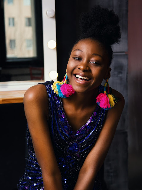 Beautiful African girl wearing multi-colored tassel-earrings