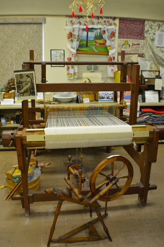 Spinning wheel by full size loom (photo by Trisha)