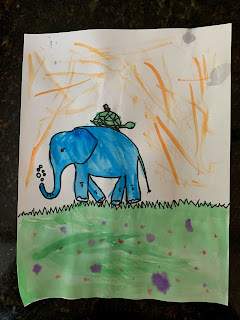 A drawing of a blue elephant with a turtle on its back walking on grass.
