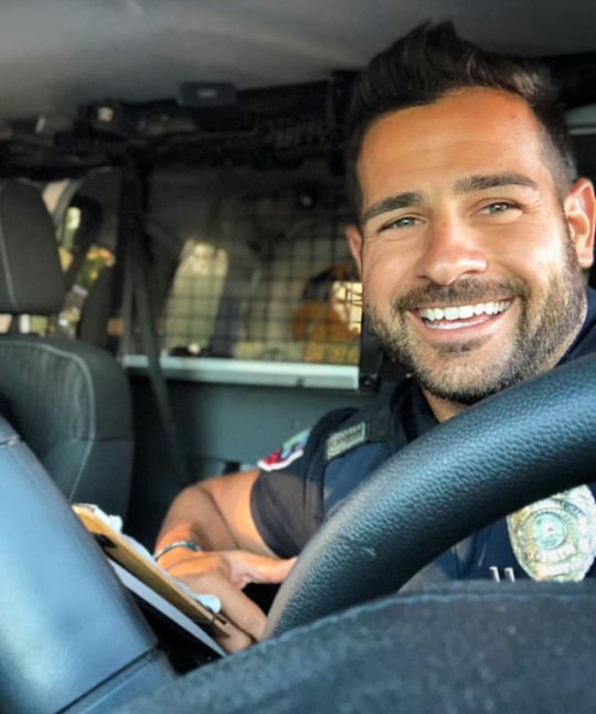 cute-policeman-smiling-car