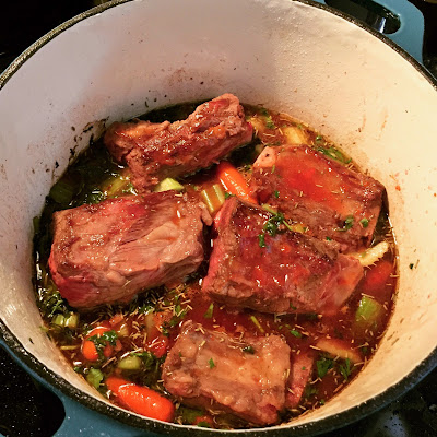 Braised beef short ribs with carrots and celery