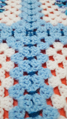 Left side of crochet blanket - well visibile and well done joining with blue