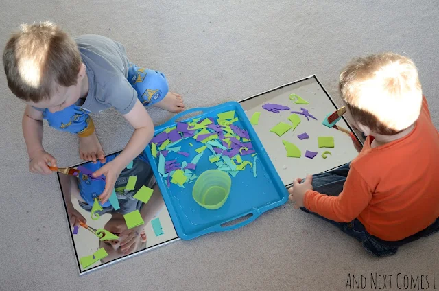 Two kids making process art for kids with mirrors, water, and craft foam