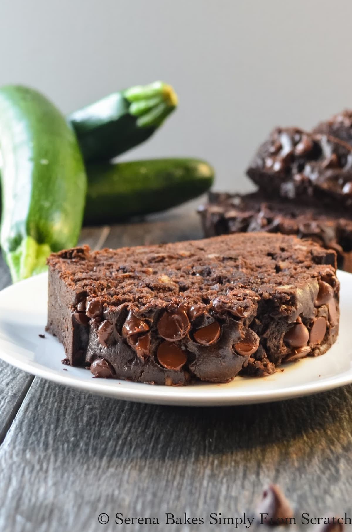 A slice of Double Chocolate Zucchini Bread on a white plate.