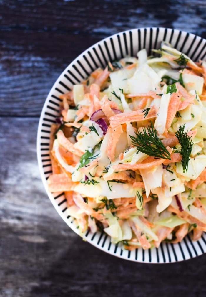vegan carrot slaw An overhead shot of carrot coleslaw in a white bowl