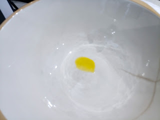 Empty earthenware bowl with a drop of oil in the bottom.