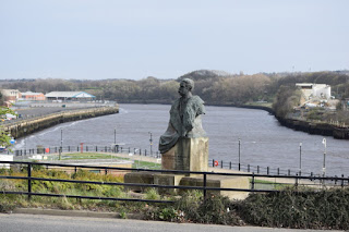 The river Tyne snakes it's way towards the coast behind the William Coulson Statue