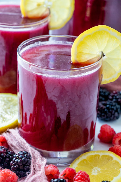 glass with berries and lemon garnish