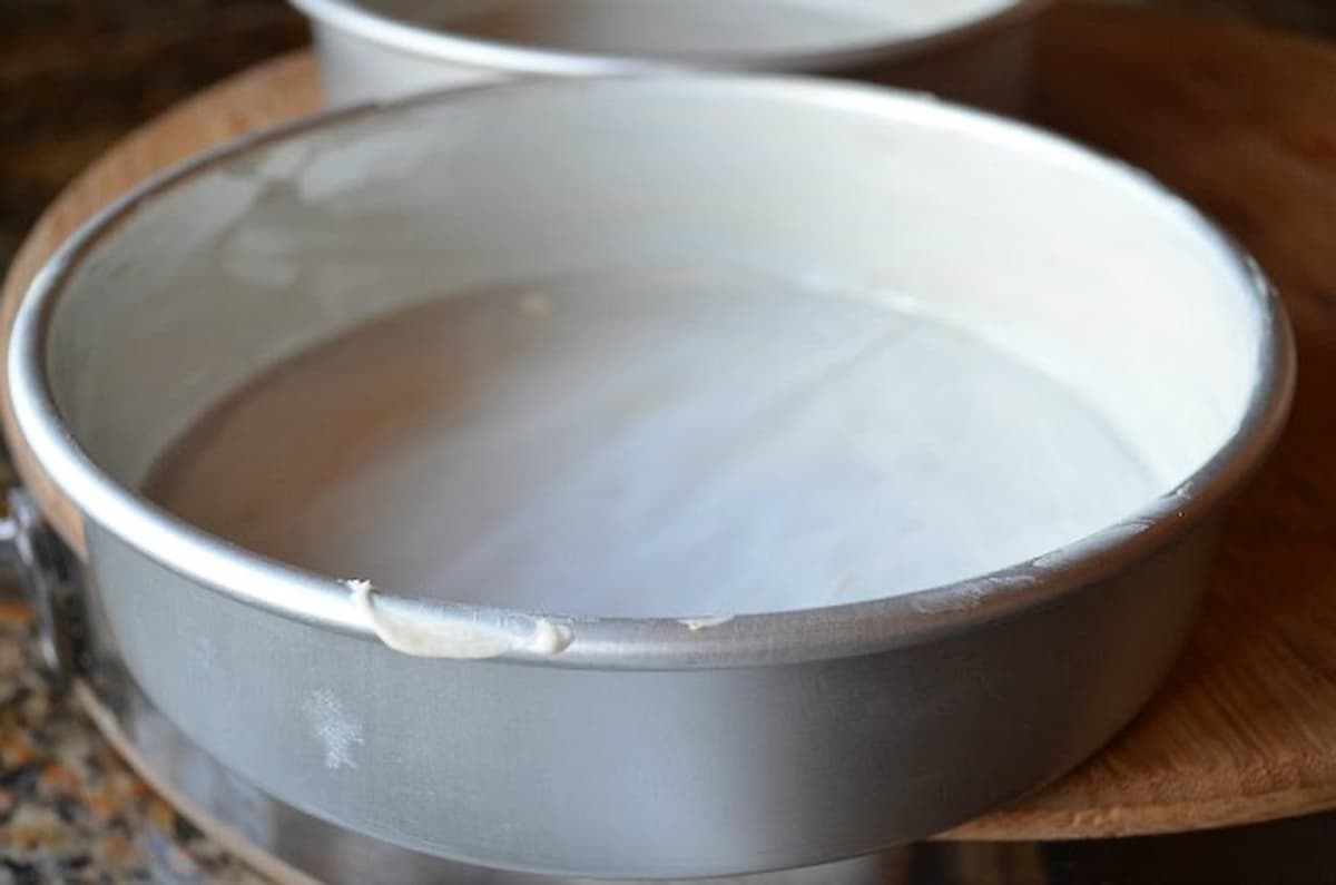 2 Buttered cake pans lined with parchment paper.