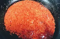 Pouring tomato onion puree for chicken Tikka masala recipe