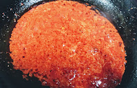 Pouring tomato onion puree for chicken Tikka masala recipe