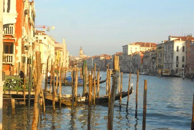 Post and gondolas along the Grand Canal in Venice in winter