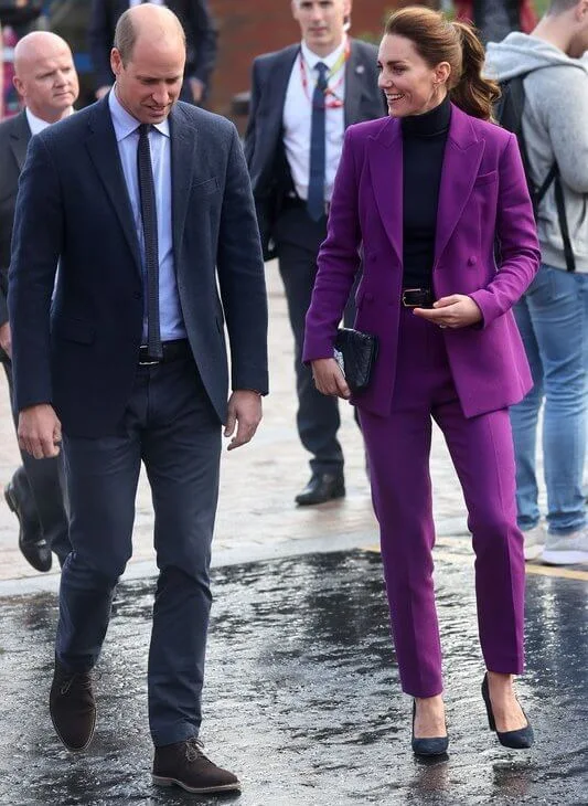 Kate Middleton wore a purple suit by Emilia Wickstead. Emmy London Josie pumps and Jaeger quilted bag