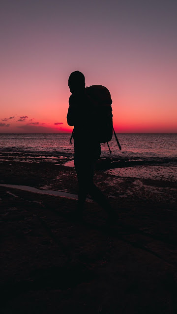 Lonely man, beach, backpack, silhouette Lonely man, beach, backpack, silhouette