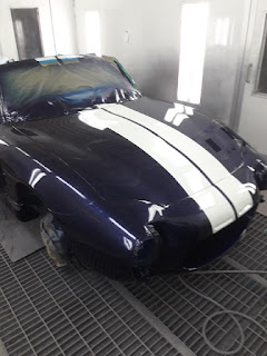 Shelby Cobra replica in the booth being painted
