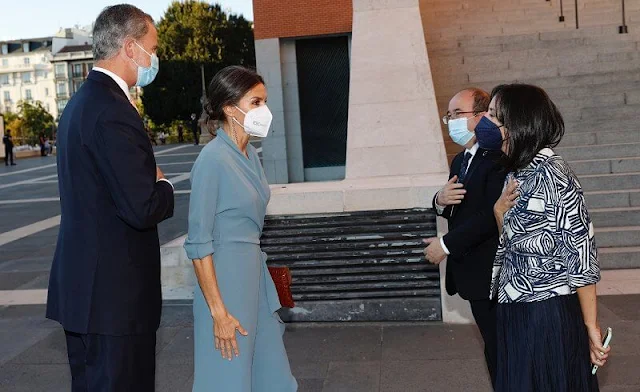 Queen Letizia wore a new wrap around dress by Adolfo Dominguez. Red pumps by Magrit. Earrings by Tous jewelry