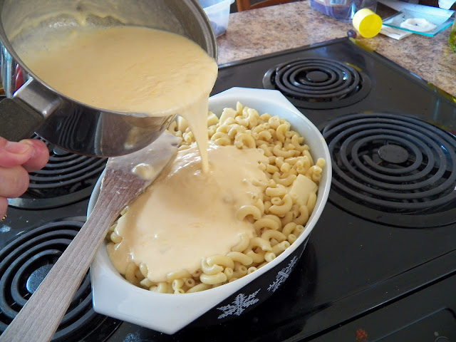 Bechamel Sauce poured over cooked macaroni and Velveeta