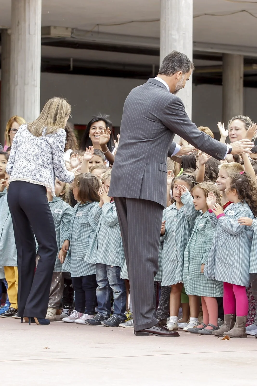 Queen Letizia speaks to a young school girl during her visit to the Ben-Cho-Shey school in Ourense.