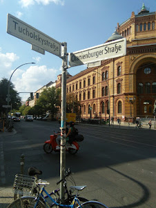 Road Sign Indicators with the defunct Berlin Post Office in the background.