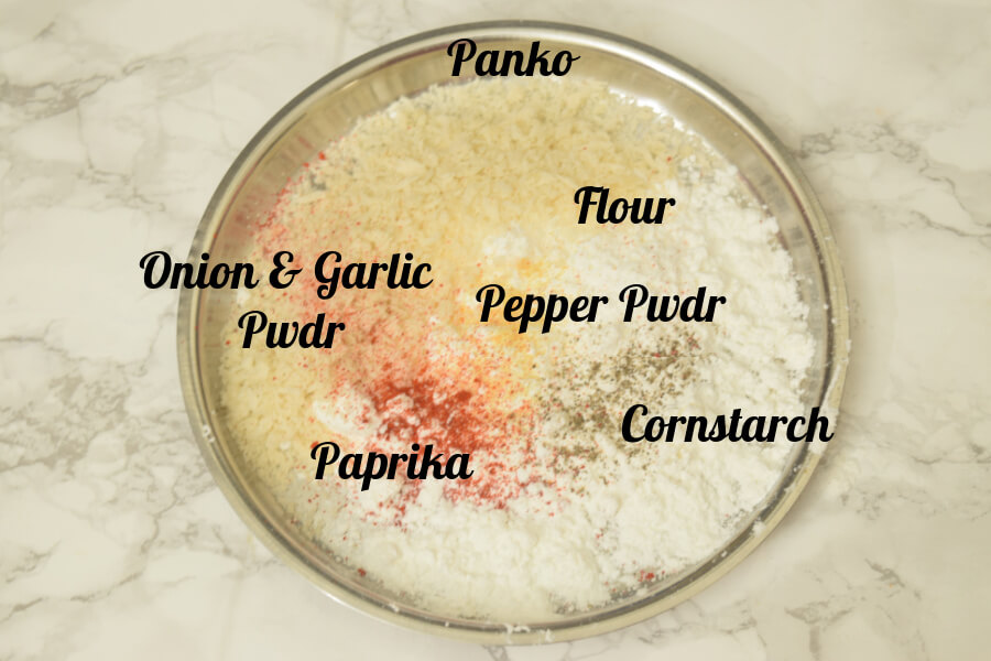 plate with flour,cornstarch,onion pwdr,garlic pwdr,pepper powder,paprika - mixed  together
