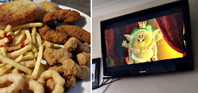 Fried chicken, fries and onion rings and Trolls on the TV