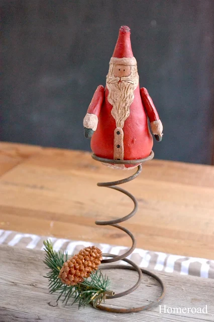 Santa on rusty spring with pine cone