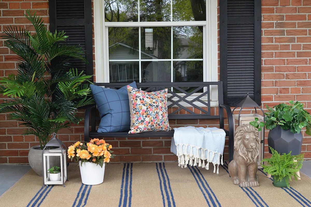 front porch decorated with artificial outdoor plants