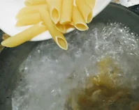 Pasta cooking in boiling water for pasta in white sauce recipe