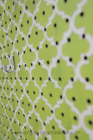 Laundry Room wall with stencilled pegboard to cover ugly pipes | OrganizingMadeFun.com