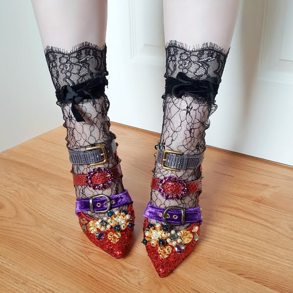 wearing black lace socks and red shoes with multi buckle strap fastenings