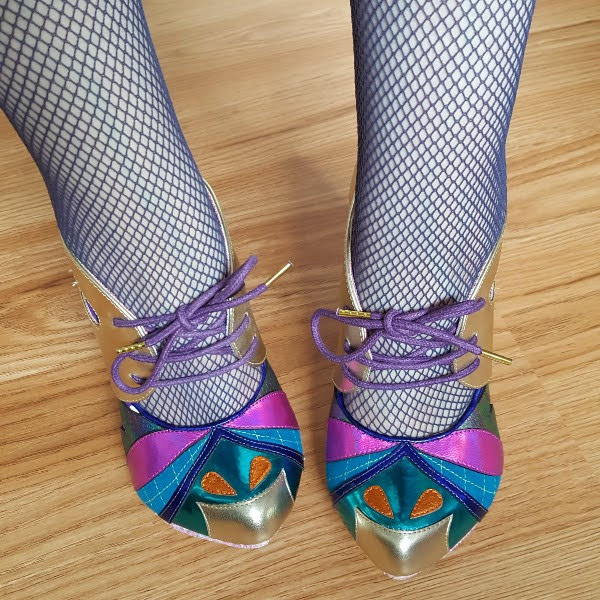 wearing multi coloured metallic and glitter shoes with fishnet tights