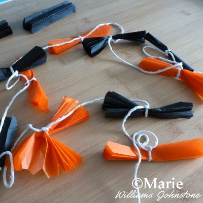 Black and orange color strips of paper tied onto cord